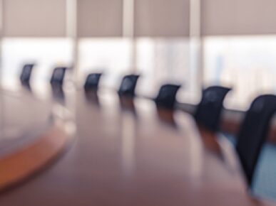 blurred image of chairs around a boardroom table