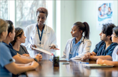 photo of medical professionals of various genders and races around a table