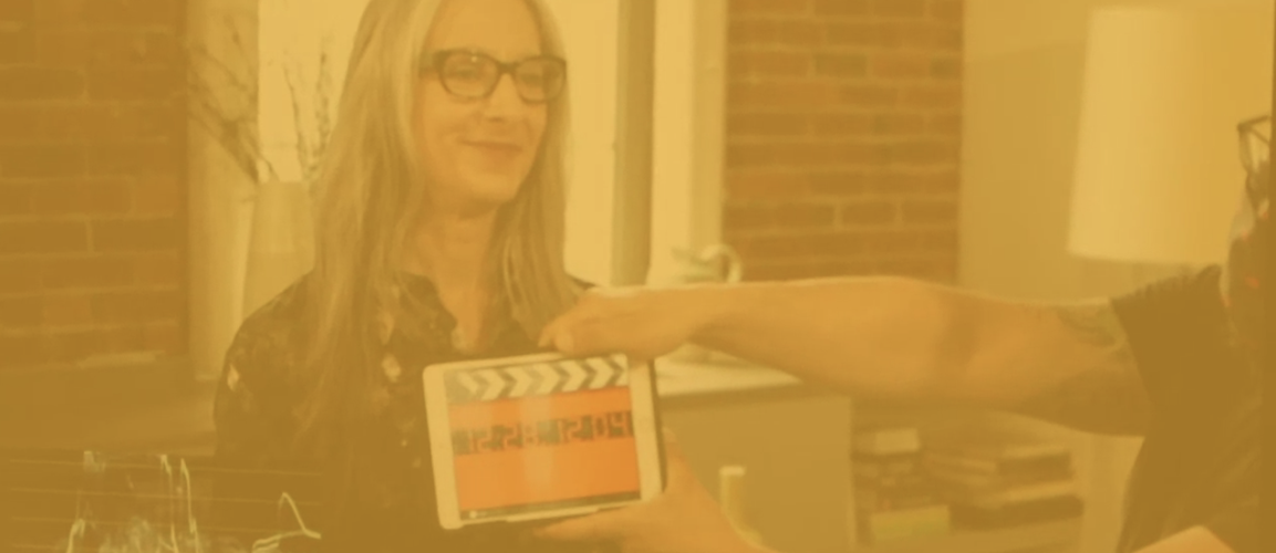 Sarah Kaplan on set with someone clapping a clap board