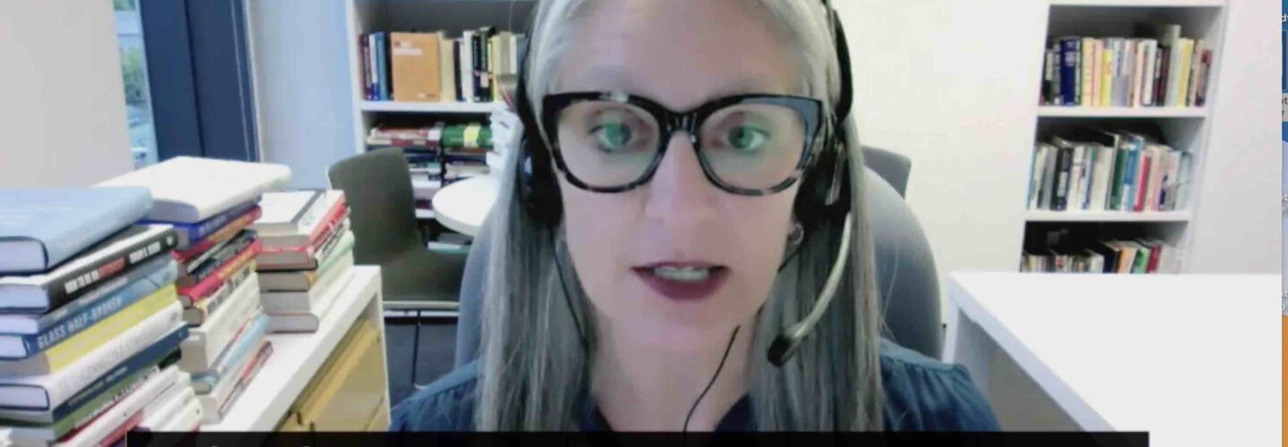 sarah kaplan with headset on in screen capture of video appearance
